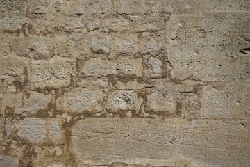 Alte braun-graue Backsteinwand bei Sonne am Nachmittag im Frühling