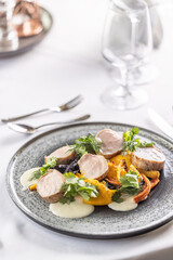Meat and vegetable with pork medallions, greens and carrot pure with baked carrots