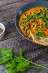 Vegan Chickpea curry on a dark background. Close-up. Healthy vegetarian food concept. Traditional Indian food concept.