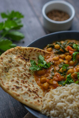 Vegan Chickpea curry on a dark background. Close-up. Healthy vegetarian food concept. Traditional Indian food concept.