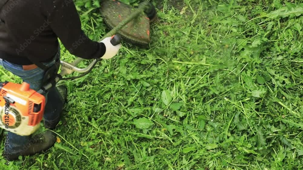 Poster man mowing grass with a trimmer