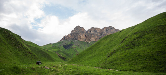 Summer mountain landscape. Amazing view of the valley and lush green pastures in the Caucasus,...