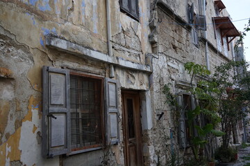 Fototapeta na wymiar Medieval narrow streets and old ruined houses in old Rhodes town, Greece