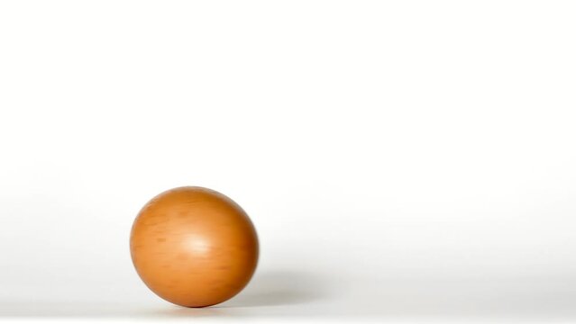 The egg spins from rest and continues to spin. Continuous rotation. On a white background