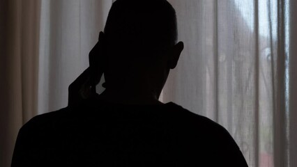 Silhouette of a man calling on the phone - Powered by Adobe