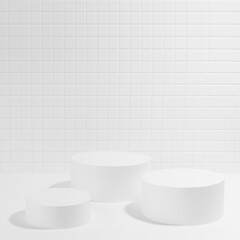 White abstract stage mockup with three cylinder podiums in hard light, shadow, template for presentation cosmetic products, spa, goods, advertising, display,  mosaic tile in exquisite beauty style.