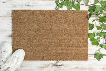 Coir doormat mockup with green plant decoration on white wooden background