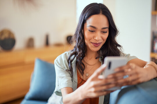 Happy mixed race woman using phone with new app