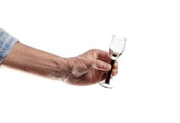 Men's hand holding empty shot glass isolated on a white background. Concept of alcohol, drink, party, degustation, holiday