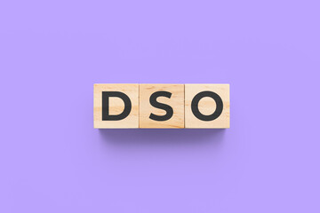 DSO (Days Sales Outstanding) wooden cubes on purple background