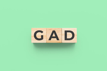 GAD (Generalized Anxiety Disorder) wooden cubes on green background