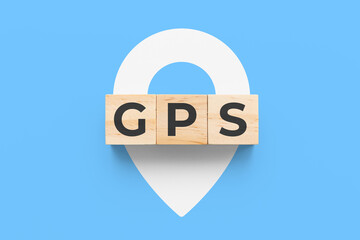 GPS (Global Positioning System) wooden cubes on blue background with white pin icon