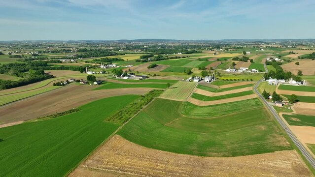 Sprawling farmland in USA. Aerial establishing shot of rolling hills in rural Pennsylvania. Amish and Mennonite farms.