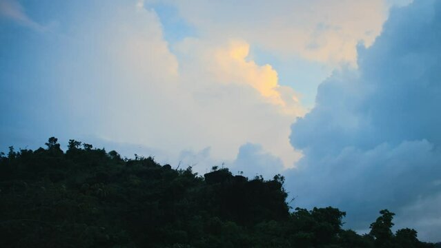 Colorful clouds behind green jungle hill in Siargao, Philippines