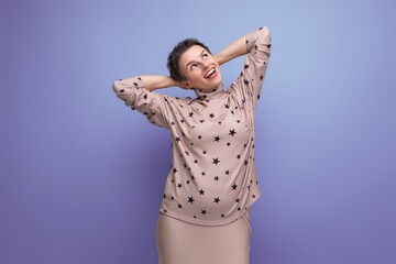 successful well-groomed young career woman with gray streaked hair dressed in a skirt and blouse posing against the backdrop of copy space