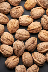 Whole walnuts nuts with shells close-up background studio shot
