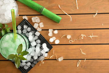 Background with natural iced mint beverage on wooden table