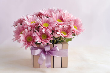 Beautiful colorful chrysanthemum and colorful flower bouquet and pink gift box on white table background for Birthday Gift, ai generative