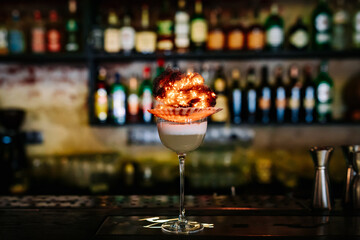 alcoholic cocktail in a glass stands on a table in a bar or restaurant
