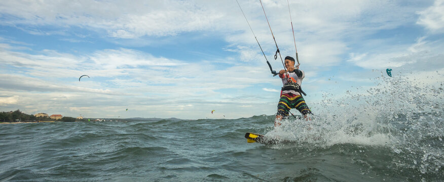 A kite surfer rides the waves