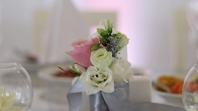 Wedding table decoration by beautiful bouquet of fresh roses.