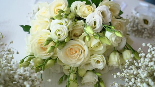 Beautiful wedding bouquet of fresh white roses on the table.