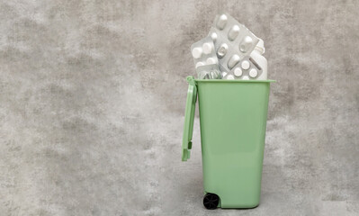many pills tablets capsules spread on surface in woman hand or bottle.wooden spoon in row with...