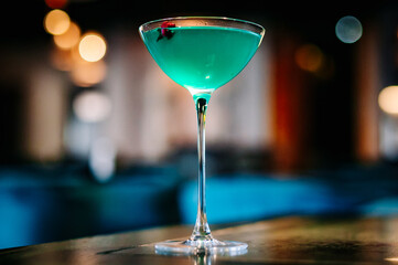 alcoholic cocktail in a glass stands on a table in a bar or restaurant
