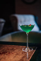 alcoholic cocktail in a glass stands on a table in a bar or restaurant