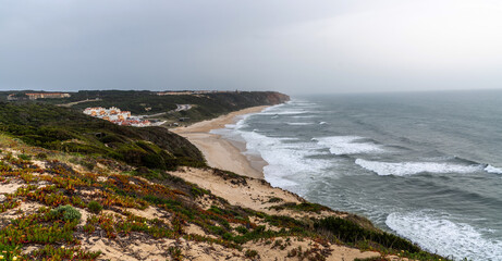 Fototapeta na wymiar Majestic coastline looking the Atlantic Ocean. View of nature landscape shore walkway to the beach, Portugal.