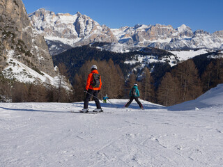 Alpine Skiers Descending a Beautiful Snowy Slope and a view of the Beautiful Surrounding Landscape...