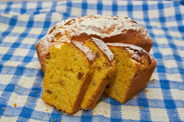 homemade cupcake on the tablecloth,classic square cupcake on a blue tablecloth cut into slices