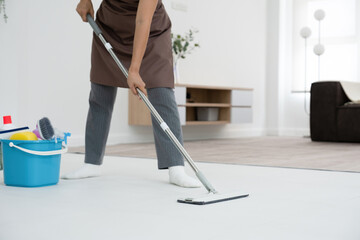 Fototapeta premium Woman, housewife mopping floor at home.
