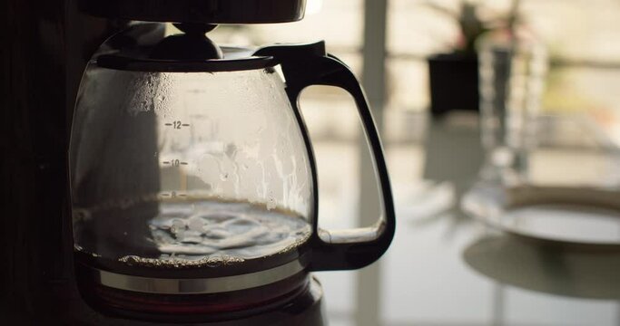 Preparing filter coffee at home in the kitchen. Coffee for breakfast in the morning in a warm atmosphere. High quality 4k footage