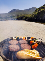 Obraz premium Making barbecue on sandy beach by the river at Silverstrand, county Mayo, Ireland 