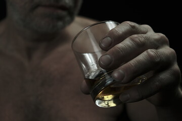 A man drinks from a glass. The man's face is not visible.