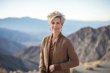 Fototapeta na wymiar Environmental portrait photography of a glad mature woman wearing a chic cardigan against a scenic mountain overlook background. With generative AI technology