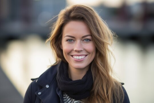 Headshot portrait photography of a happy girl in her 30s wearing a chic cardigan against a busy marina background. With generative AI technology