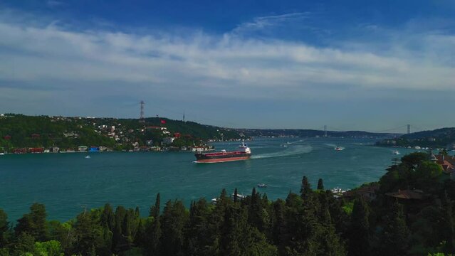 A cargo ship sails along the Bosphorus in Istanbul T&uuml;rkiye -   Aerial flying drone video