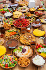 Homemade Romanian Food with grilled meat, polenta and vegetables Platter on camping. Romantic traditional moldavian food outside on the wood table.