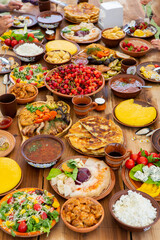 Homemade Romanian Food with grilled meat, polenta and vegetables Platter on camping. Romantic traditional moldavian food outside on the wood table.