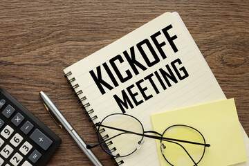 glasses on a notebook with the text Kick-Off Meeting on the desktop