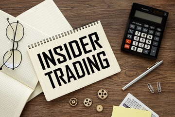 INSIDER TRADING open notepad with text on notebook on work table