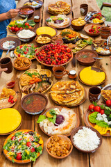 Homemade Romanian Food with grilled meat, polenta and vegetables Platter on camping. Romantic traditional moldavian food outside on the wood table.
