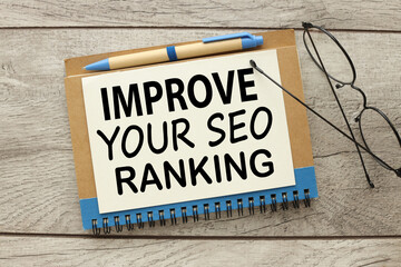 Improve Your Seo Ranking a blank sheet of paper on a notepad near the glasses . Business concept.