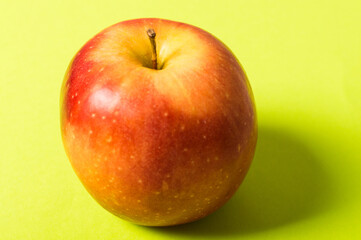 Eco food. Healthy vegan fruit. Red apple on the green background.