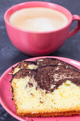 Fresh baked yeast cake with cocoa, cup of cappuccino. Delicious dessert