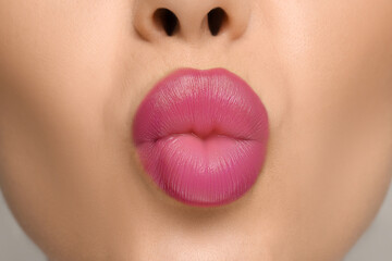 Closeup view of woman with pink lipstick