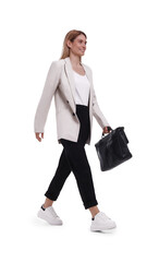 Beautiful happy businesswoman with briefcase walking on white background