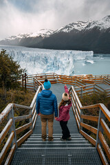 Travelers couple in love posing on the ice formation of the Perito Moreno glacier, Argentina